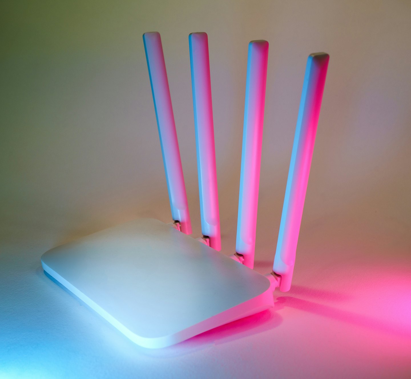 Modern white Wi-Fi router with glowing blue and pink lights.