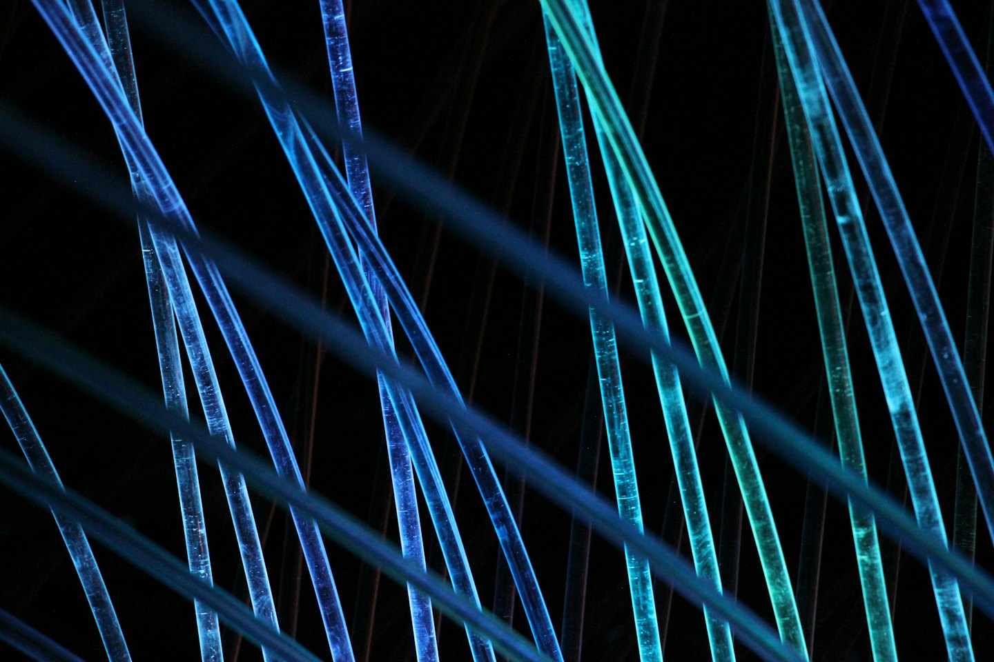 Blue and teal fiber optic cables create a sense of connection.