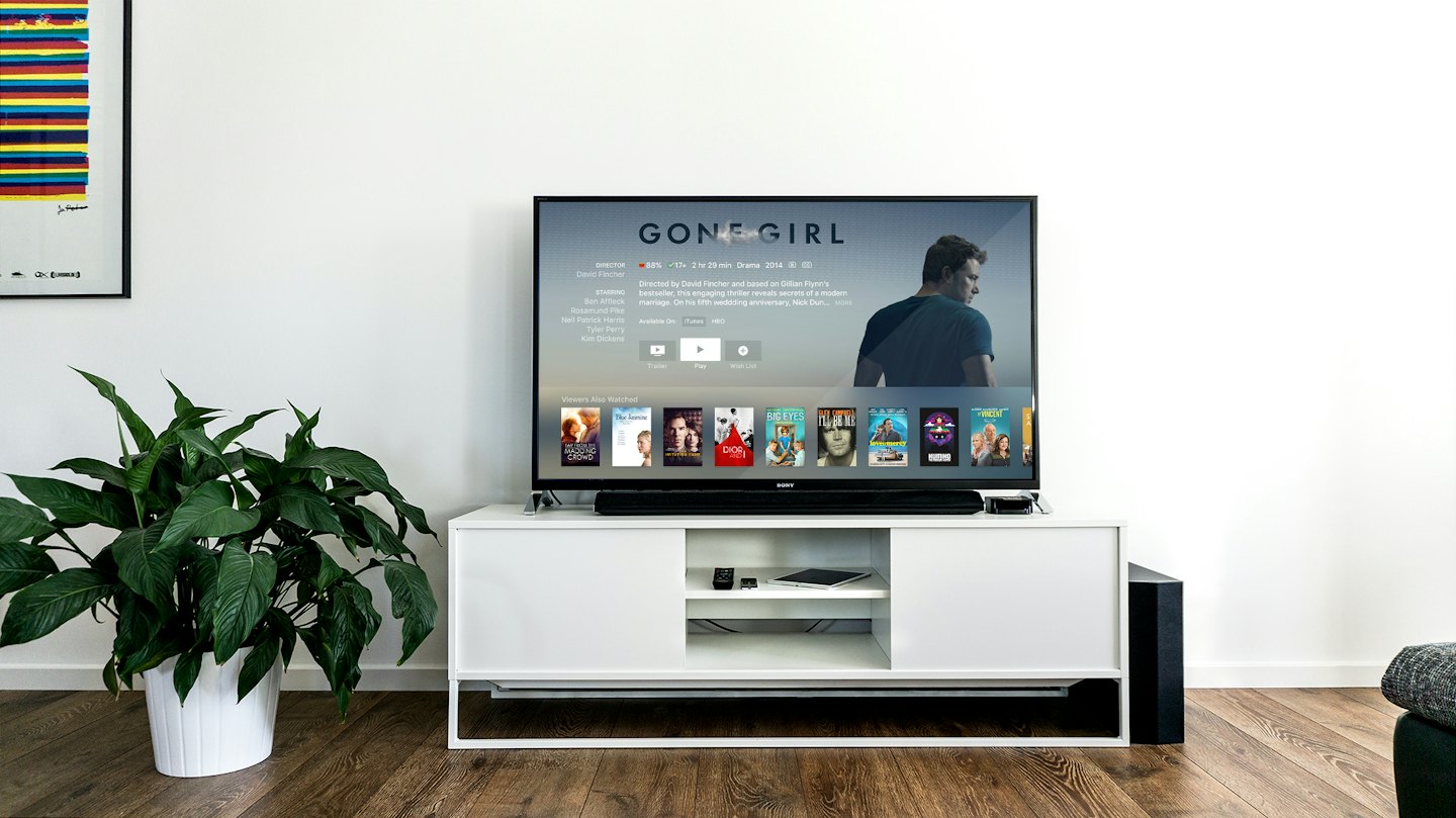 Television displaying movie choices on a media console.
